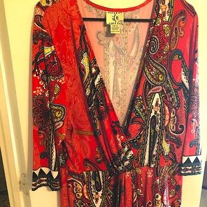 Knee length flowy, stretch, faux wrap dress, bright colors and pattern. Low cut.